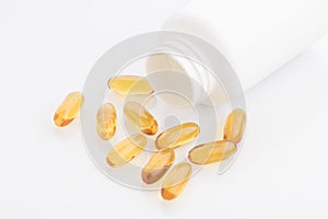 Medical : Close up of Omega 3 Capsules with Bottle on White Background Shot in Studio.