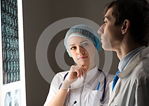 Medical colleagues confer near the x-ray image