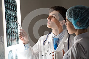 Medical colleagues confer near the x-ray image