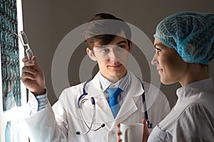 Medical colleagues confer near the x-ray image