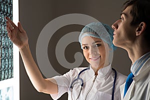 Medical colleagues confer near the x-ray image