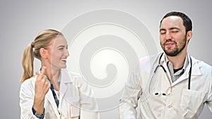 Medical collegues celebrating, dancing and singing on white background.