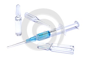 Medical concept: ampules and syringe with blue vaccine