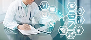 Medical concept - Doctor on Computer with Icons