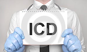 Medical concept. Doctor is writing the word icd on white paper notepad photo
