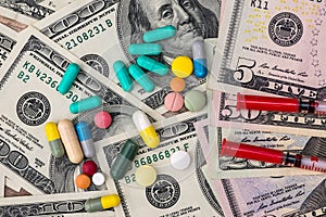 Medical concept - dollars , pills and syringes