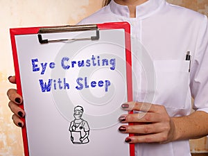 Medical concept about Eye Crusting With Sleep with inscription on the page photo