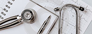 Medical concept flat lay with stethoscope, cardiogram and medical prescription on the doctor desktop