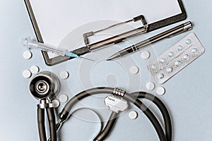 Medical concept flat lay with stethoscope  pills  notepad  pen on the doctor desktop