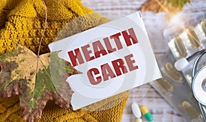 Medical concept of health care. Nurse holding colorful pils foam notepad with health care text