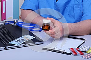 Medical concept - health price. dollars with assorted pills, cardiogram rx and stethoscope.