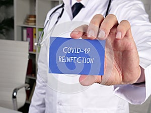 Medical concept meaning COVID-19 REINFECTION with sign on the piece of paper photo
