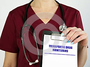 Medical concept meaning THERAPEUTIC DRUG MONITORING with inscription on the sheet