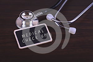 Medical Concept- MEDICAL CHECK UP words written on label tag with Stethoscop