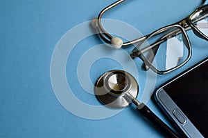 Medical concept. Stethoscope on doctor desk. Blue background