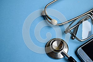 Medical concept. Stethoscope on doctor desk. Blue background