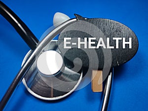 Medical concept,with text E-HEALTH on wooden board with stethoscope.