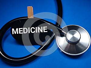Medical concept,with text MEDICINE on wooden board with stethoscope.