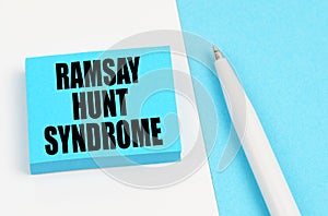 On a white and blue surface, a pen and blue stickers with the inscription - Ramsay hunt syndrome photo