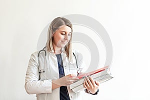 Medical conceptual, hospital or clinic medical service. young intern nurse holding a clipboard