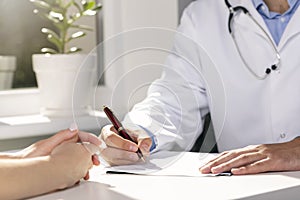 Medical consultation - doctor and patient sitting by the table