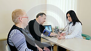 Medical consultation for the elderly, a female doctor checks blood pressure.