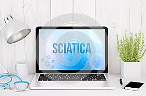 medical desktop computer with sciatica on screen