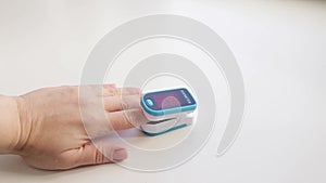 Medical device for hypoxia. A woman`s finger in a pulse oximeter