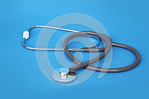 Medical device for listening stethoscope on a blue background, concept of medicine and healthcare, top view, close-up, copy space