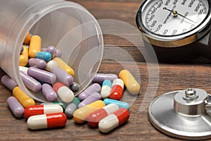 Medical Devices and Scattered From Vial Pills on Wooden Table