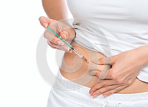 Medical diabetes insulin syringe injection shot into abdomen wit photo