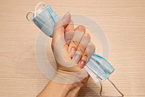 Medical disposable mask for protection against carpet crumpled with force in the left female hand