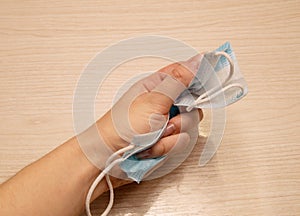 Medical disposable mask for protection against carpet crumpled with force in the left female hand