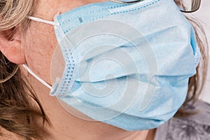 Medical disposable mask wearing on a face close-up