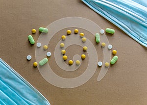 Medical disposable protective masks and inscription from pills sos on a light background. Coronavirus concept