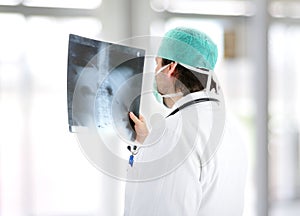 Medical doctor analysing x-ray image handheld photo