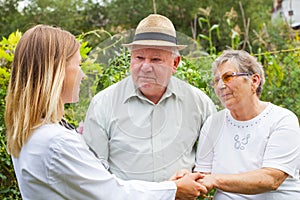 Medical doctor with elderly couple