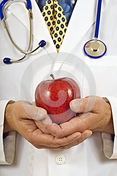 Medical Doctor Gently Holding Red Apple Vertical Shot