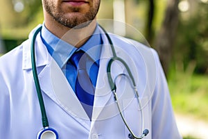 A medical doctor holds a stethoscope in hand, ready to attend to patients hospital.