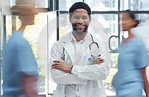 Medical doctor, man nurse and crossed arms healthcare professional in busy hospital. Portrait, happy face expression and