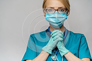 Medical doctor nurse woman wearing protective mask and latex gloves - praying nad hoping gesture