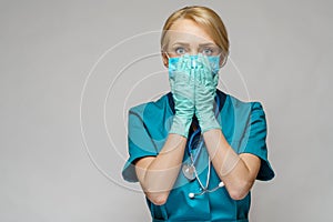 Medical doctor nurse woman wearing protective mask and latex gloves - praying nad hoping gesture