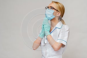 Medical doctor nurse woman wearing protective mask and latex gloves - praying nad hoping gesture