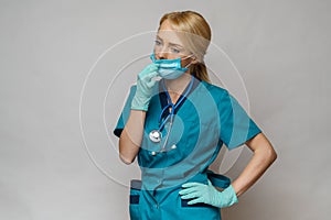 Medical doctor nurse woman wearing protective mask and rubber or latex gloves - tired and stressed photo