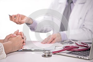 Medical doctor and patient discussing and consulting in hospital examination room