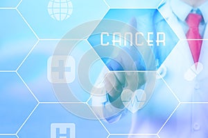 Medical doctor pressing 'Cancer' button on virtual touch screen on blue technology background