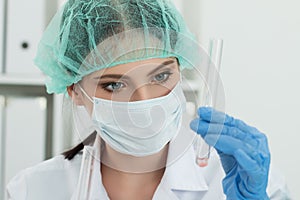 Medical doctor in protective gloves and surgical mask and hat lo