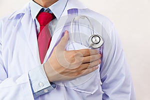 Medical doctor putting stethoscope in pocket, ready for hard work and having faith