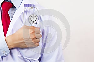 Medical doctor putting stethoscope in pocket, ready for hard work and having faith with copy space
