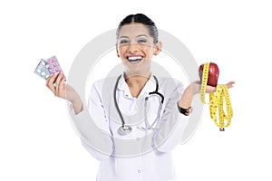 Medical doctor showing apple and pils